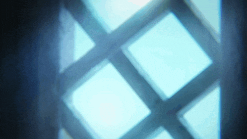 a blurry picture of a window with a blue sky in the background .