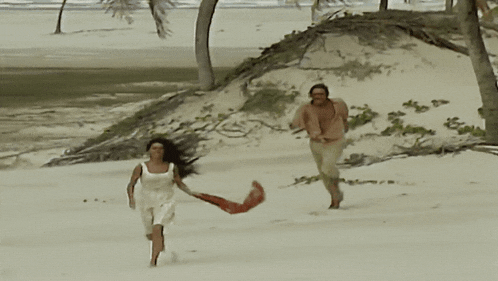 a man and a woman are running on the beach