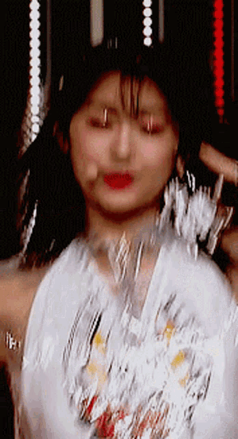 a close up of a woman 's face with a microphone in the background
