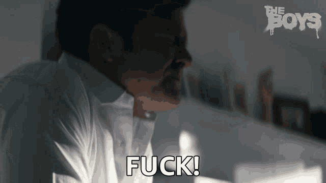 a man in a white shirt says " fuck " in front of the boys logo
