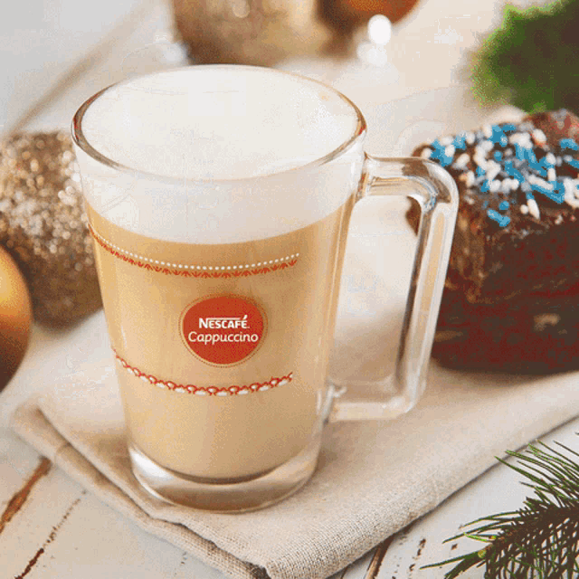 a cup of nescafe cappuccino is on a table