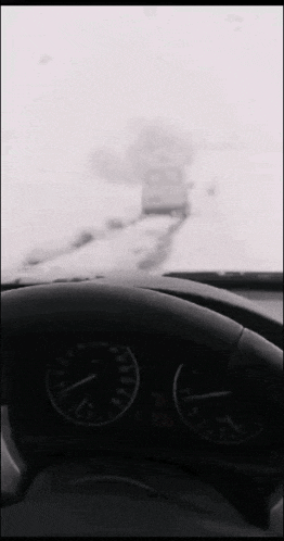 a car is driving down a snowy road with a speedometer that reads 200