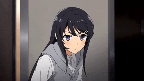 a girl with long black hair and blue eyes looks angry