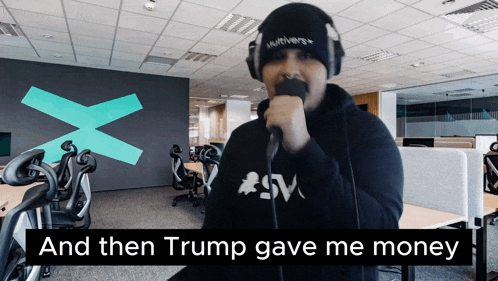 a man singing into a microphone with the words and then trump gave me money
