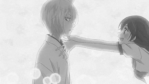 a black and white photo of a girl touching a boy 's shoulder .