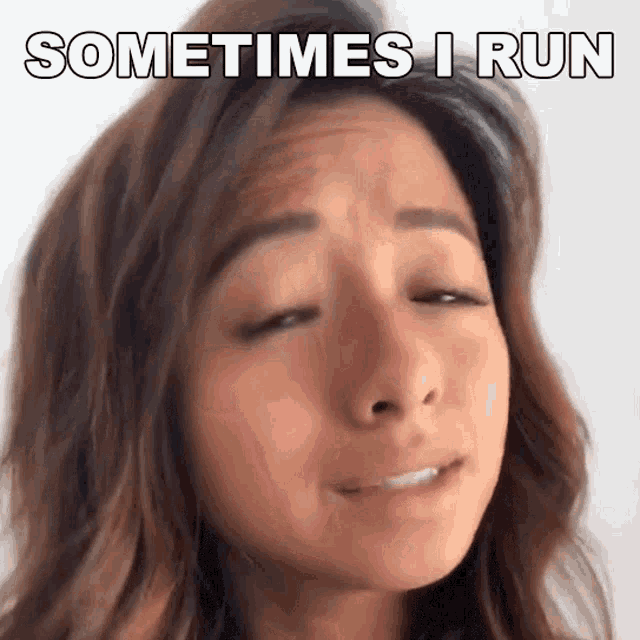 a woman is making a funny face with the words `` sometimes i run '' written on her face .