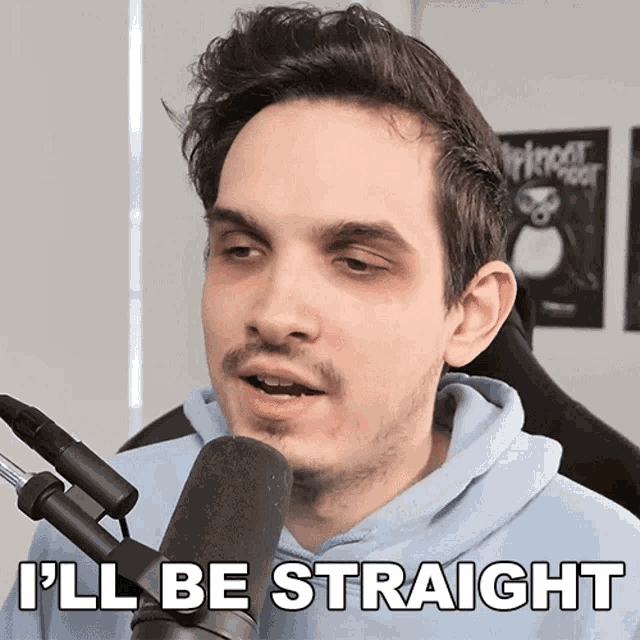 a man in front of a microphone with the words " i 'll be straight " below him