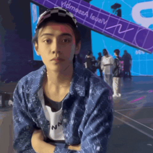 a man sitting in front of a sign that says " mc "