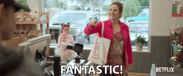 a woman in a pink jacket is giving a thumbs up and says fantastic