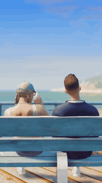 a man and a woman are sitting on a bench looking out over the ocean