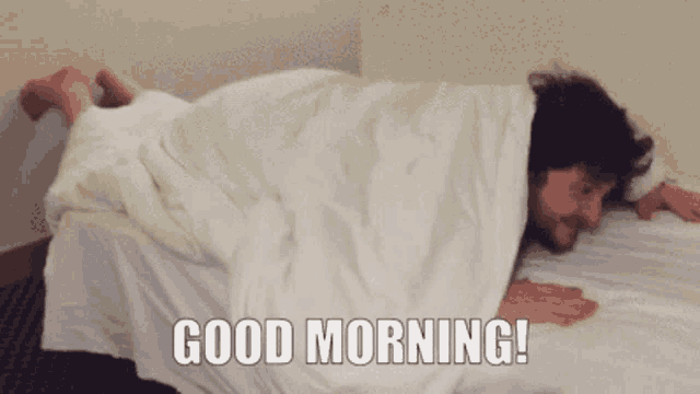 a man is laying on a bed with the words good morning written on the bottom