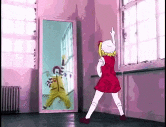 a little girl in a red dress is dancing in front of a mirror .
