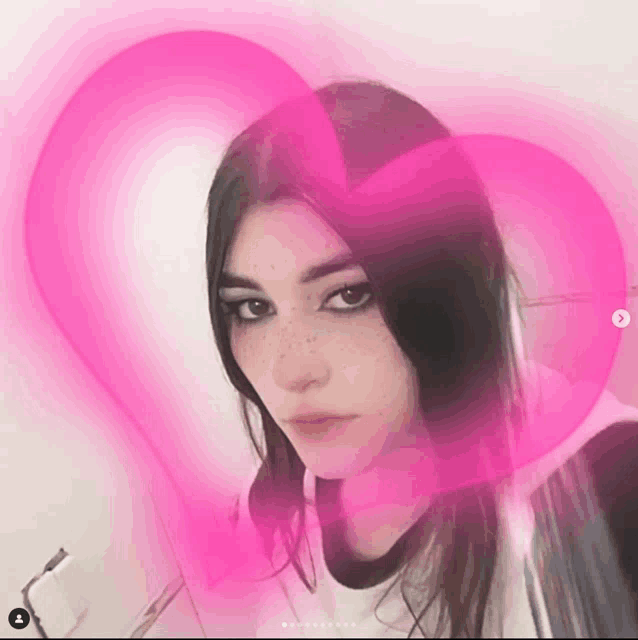 a woman with a pink heart in the background