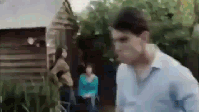 a blurry picture of a man in a blue shirt and a woman in a blue shirt
