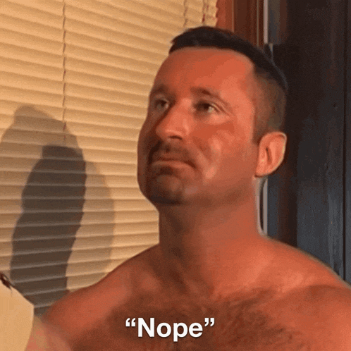 a shirtless man is standing in front of a window and says " nope "
