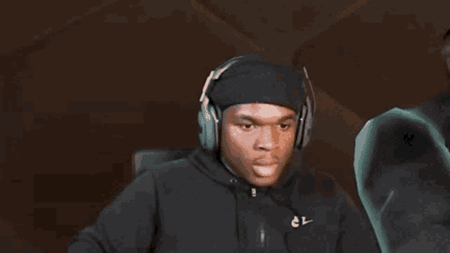 a blurry picture of a man wearing headphones and a black jacket .