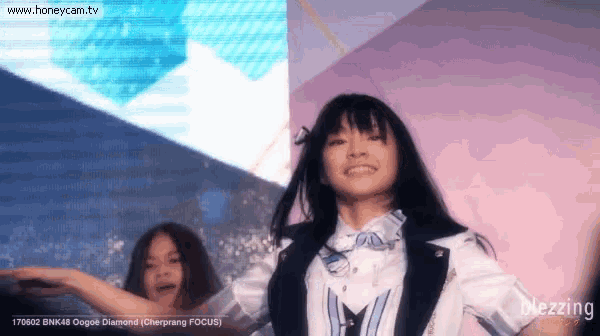 two girls are dancing in front of a screen which says honeycam.tv