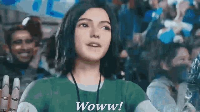 a girl in a green shirt says woww in a crowd