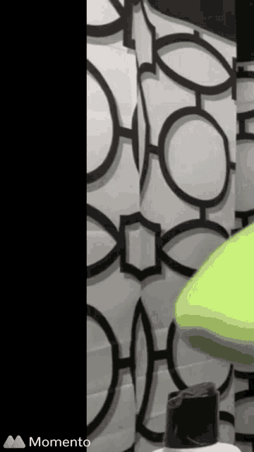 a shower curtain with black and white circles and the word momento on the bottom