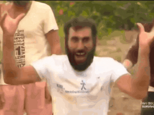 a man with a beard is wearing a white shirt that says ' yeni bol survivor ' on the front