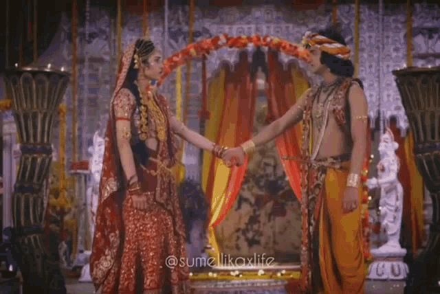 a man and a woman are holding hands with a ring on their fingers .