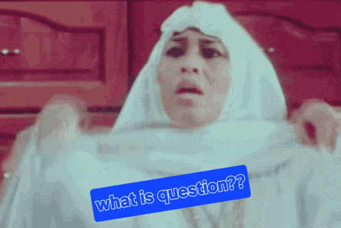 a woman wearing a white hijab has a blue sign that says what is question