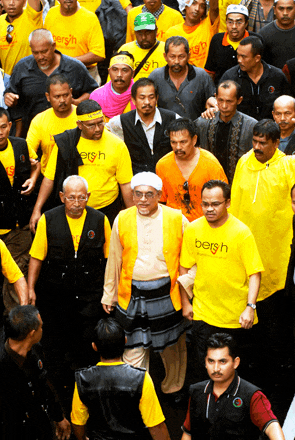 a group of men wearing yellow shirts that say bersh