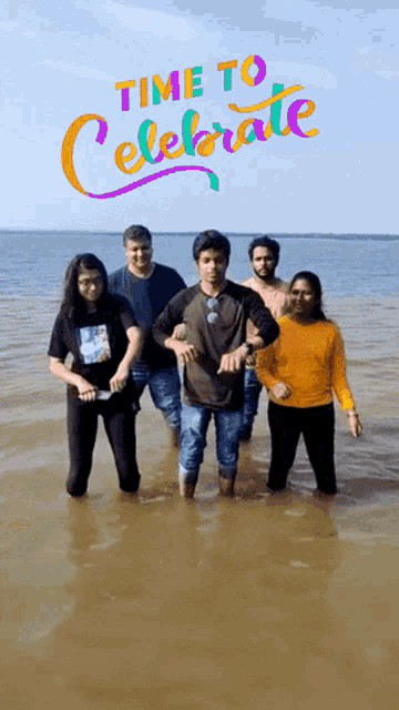 a group of people are standing in the water with the words time to celebrate behind them