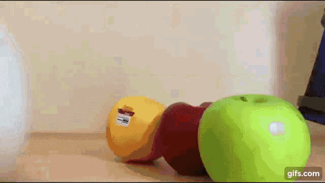 a bunch of fruit including an apple and a grapefruit