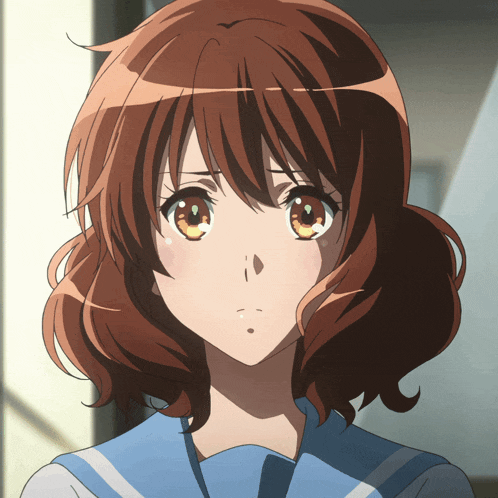 a close up of a girl 's face with brown hair and yellow eyes