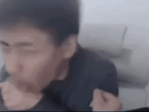 a close up of a man 's face with a blurred background while sitting on a couch .