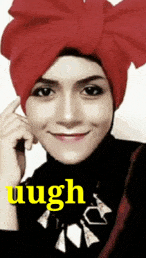 a woman wearing a red turban and a black turtleneck has the word laugh written on the bottom right