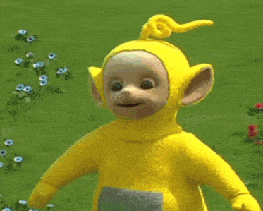 a group of teletubbies are standing in a field