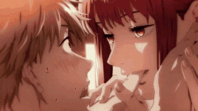 a man and a woman are kissing in a close up of their faces .