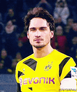 a soccer player wearing a yellow jersey with bvb on the front
