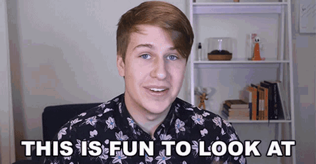 a young man in a floral shirt is smiling with the words this is fun to look at behind him