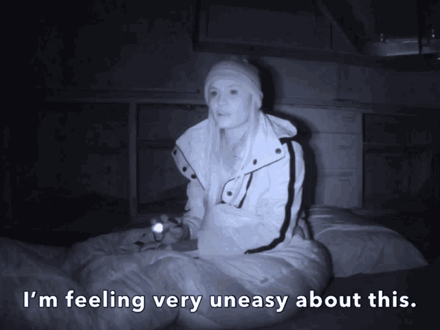 a woman sitting in a sleeping bag with the words i 'm feeling very uneasy about this below her