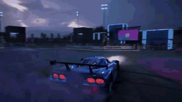 a car is driving down a street at night