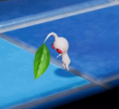 a white and red cartoon character is holding a green leaf .