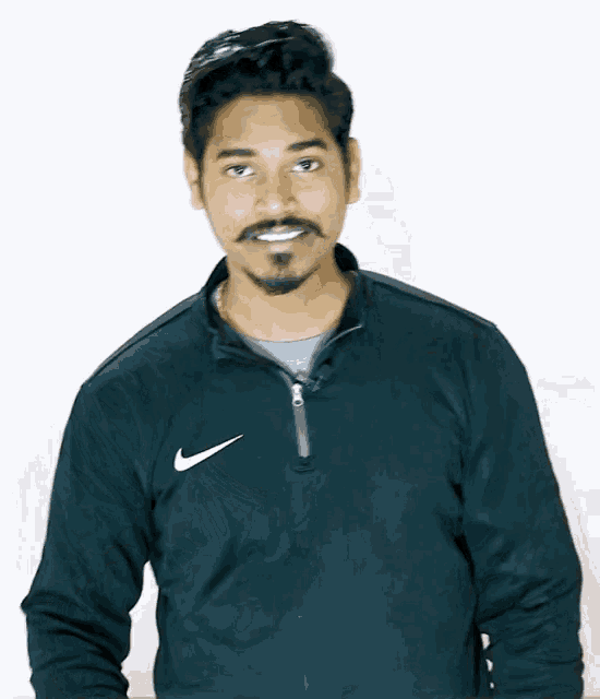 a man with a beard wears a black nike sweatshirt