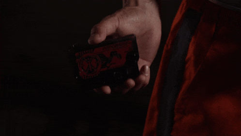 a person is holding a device that has a red light on the screen