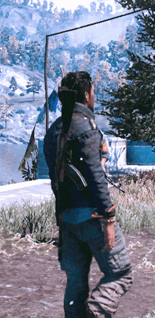 a man in a denim jacket with a gun on his back stands in a snowy field