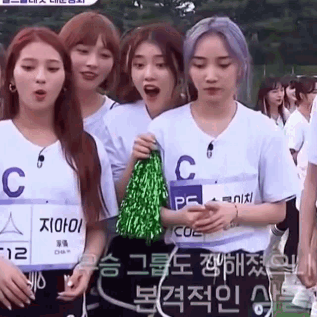 a group of girls are standing next to each other and one of them has a name tag that says c on it