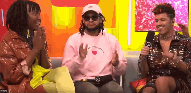 a man wearing a pink sweatshirt that says ' i love you more ' on it