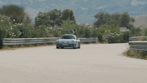 a car is driving down a road with a sign on the side that says ' a '