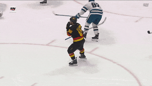 a hockey player wearing a black jersey with the number 96 on it