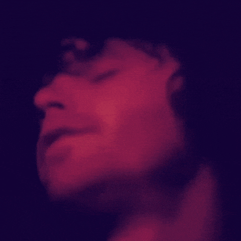 a close up of a person 's face with a red background