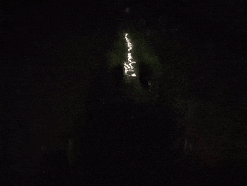 a silhouette of a person in a dark room