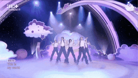 a group of girls are dancing on a stage with the words " this is my world " written on the bottom