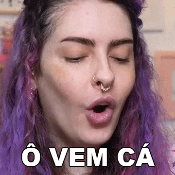 a woman with purple hair and a nose ring is making a funny face and says o vem ca .
